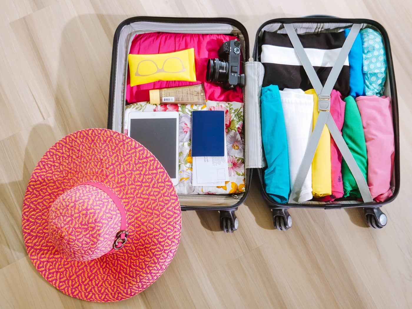 Travel clothing rolled and organized neatly inside a packed suitcase