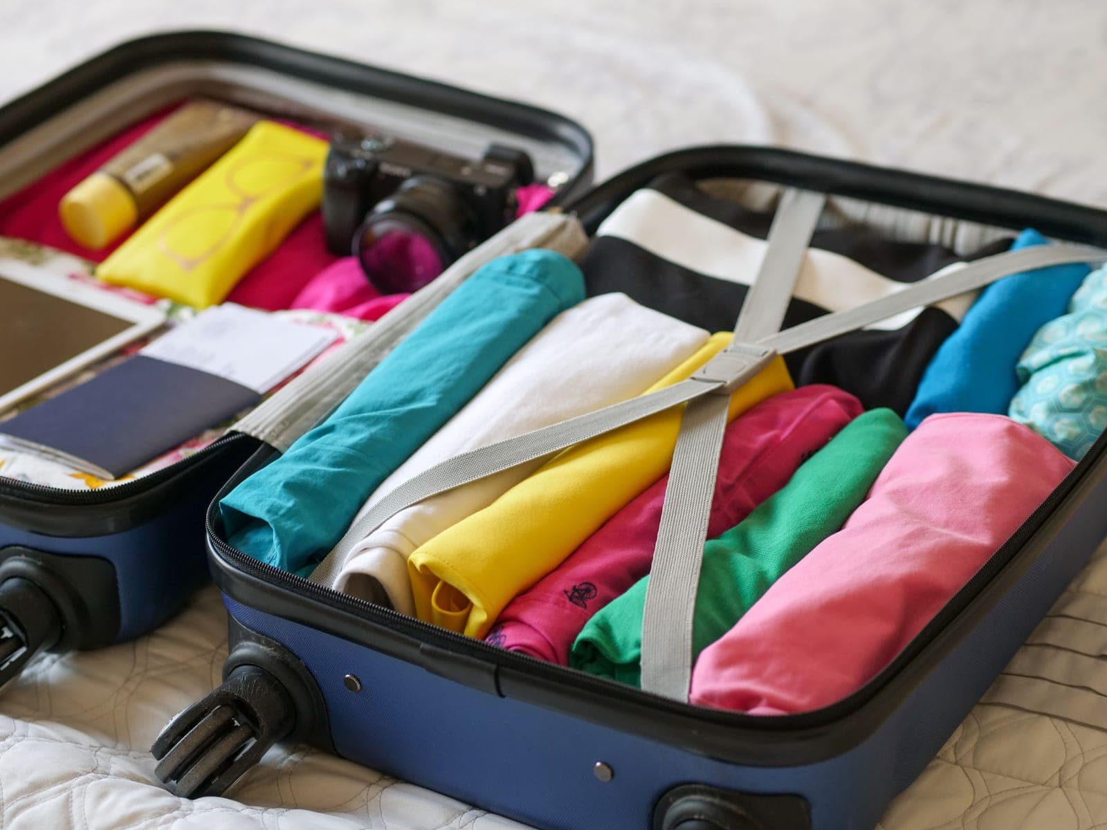 Neatly folded clothes organized into a packed suitcase